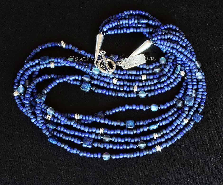 Blue Indonesian Glass 6-Strand Necklace with Lapis Squares, Blue Crystal Rounds, Iridescent Blue Seed Beads, and Sterling Silver Discs, Cones and Toggle Clasp