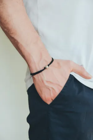 Men's bracelet with silver bead charm and a black cord