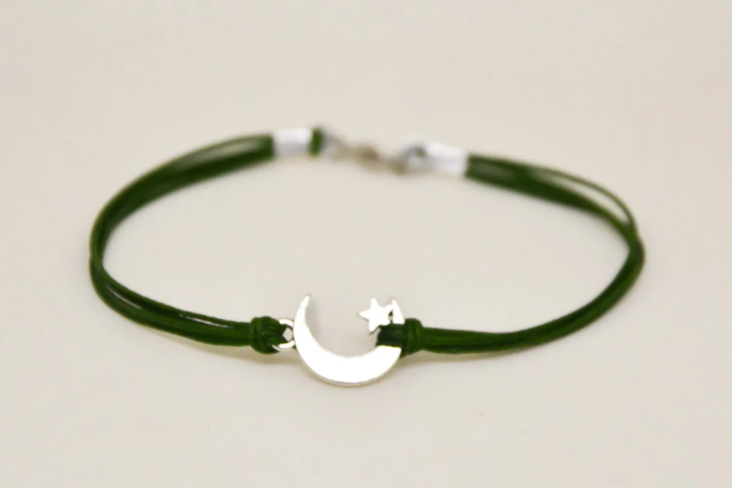 Men's bracelet with silver crescent moon charm, green cord