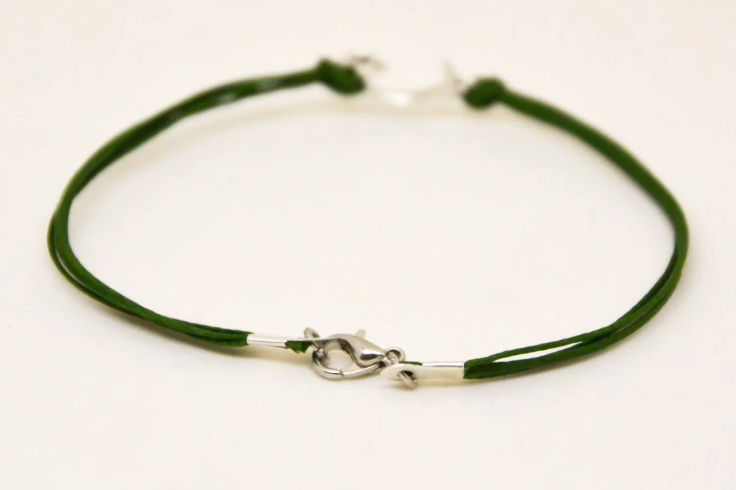 Men's bracelet with silver crescent moon charm, green cord